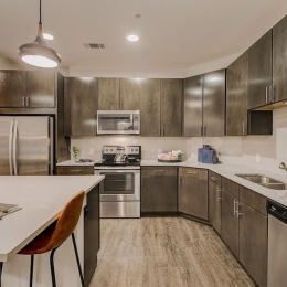 a kitchen with dark cabinets